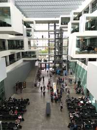 Auditorium at IT University Copenhagen, a high room with cubic architecture.